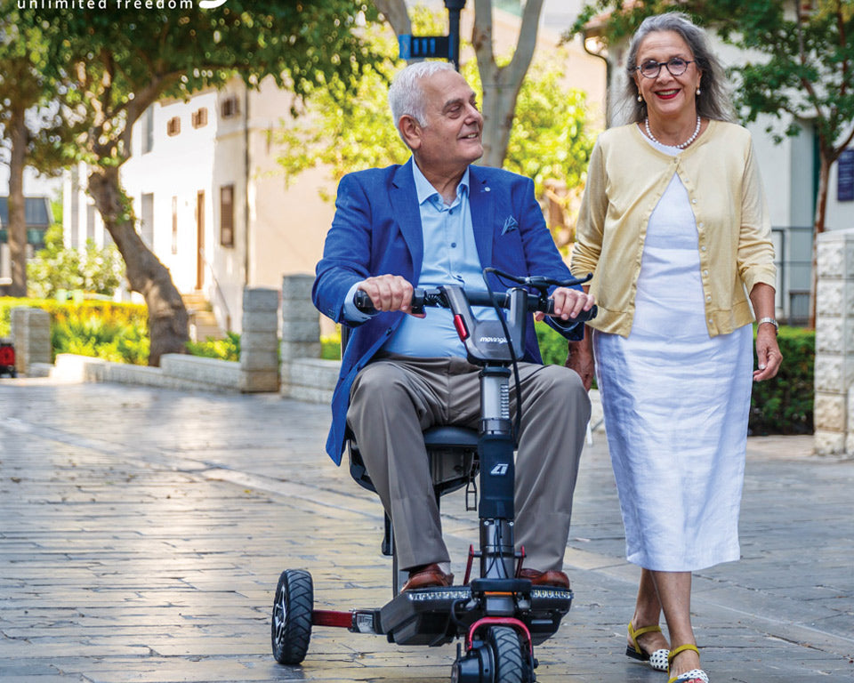 Happy couple with their Movinglife foldable mobility scooter